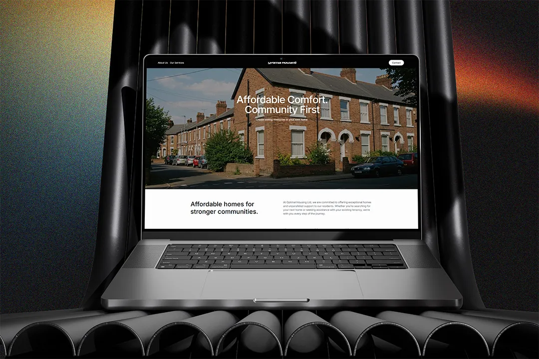 A MacBook on black roll tubes showcasing Optimal Housing Ltd Website